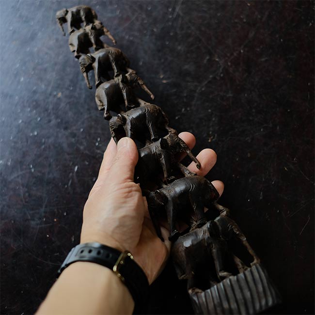 Eight carved wooden elephants