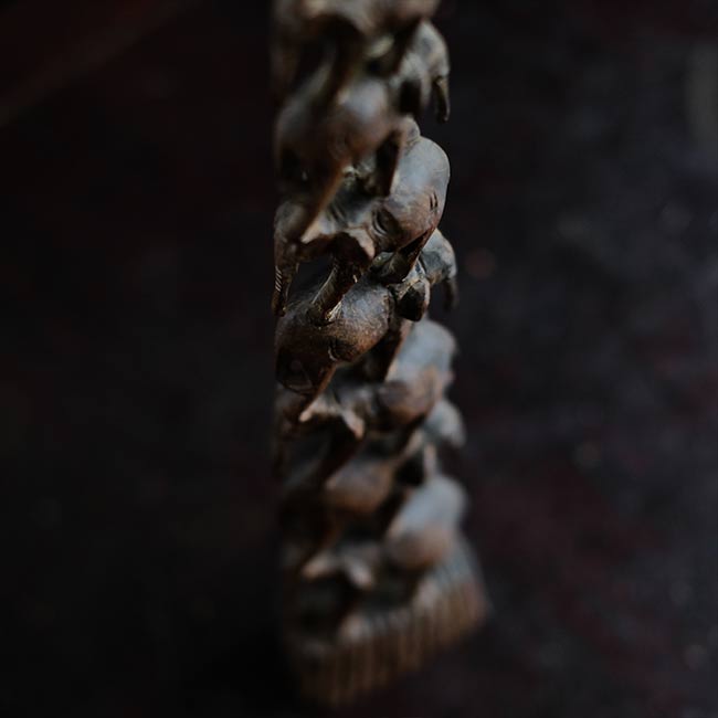Eight carved wooden elephants