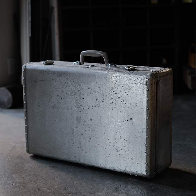A well-worn aluminum trunk