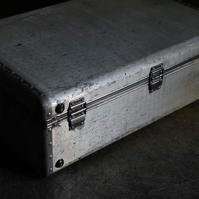 A well-worn aluminum trunk