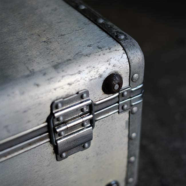 A well-worn aluminum trunk