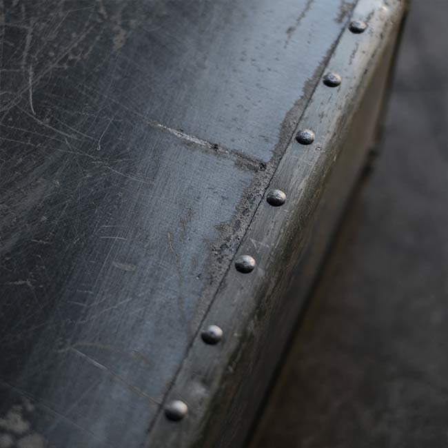 A well-worn aluminum trunk