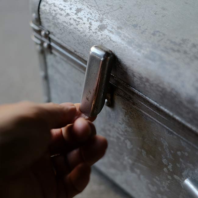 A well-worn aluminum trunk