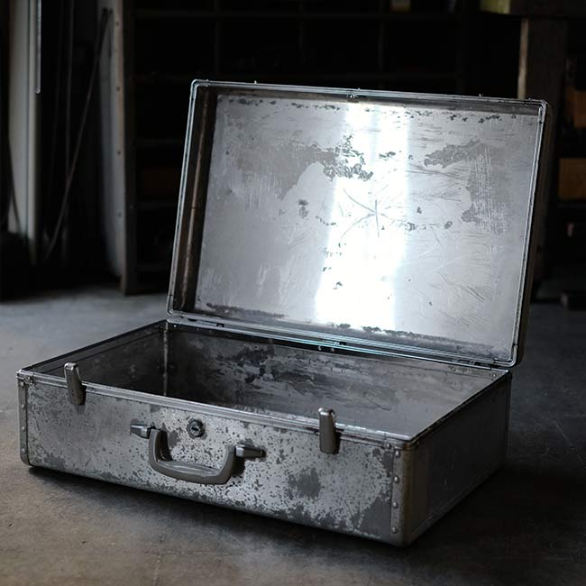 A well-worn aluminum trunk