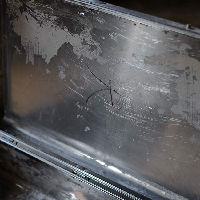A well-worn aluminum trunk