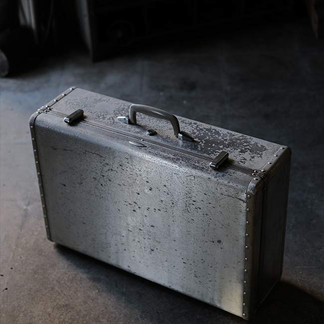 A well-worn aluminum trunk