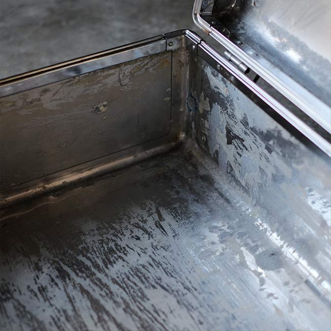 A well-worn aluminum trunk
