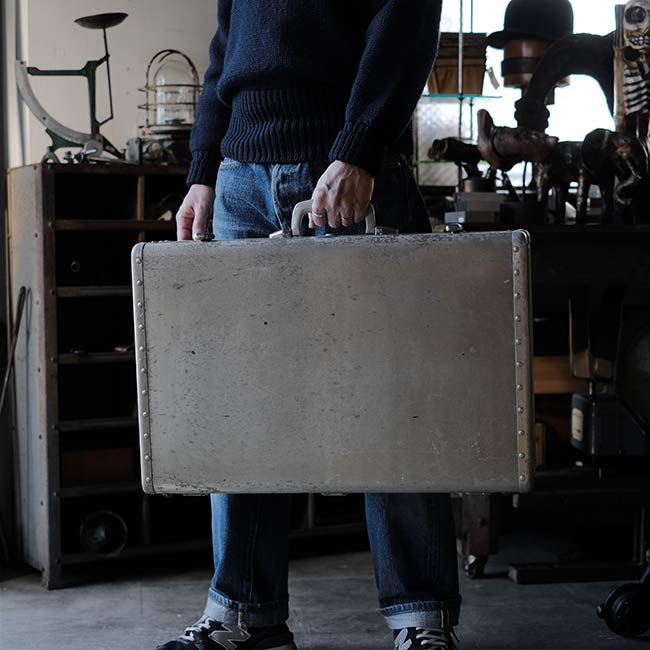 A well-worn aluminum trunk