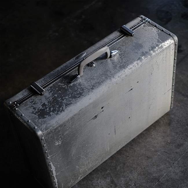 A well-worn aluminum trunk