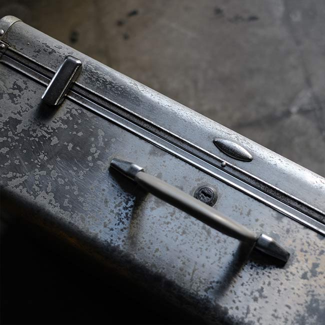 A well-worn aluminum trunk