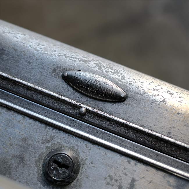 A well-worn aluminum trunk