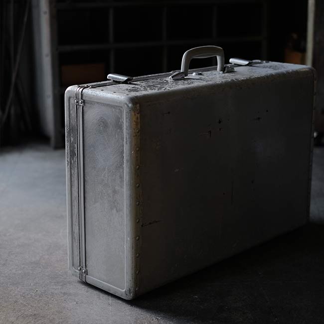 A well-worn aluminum trunk