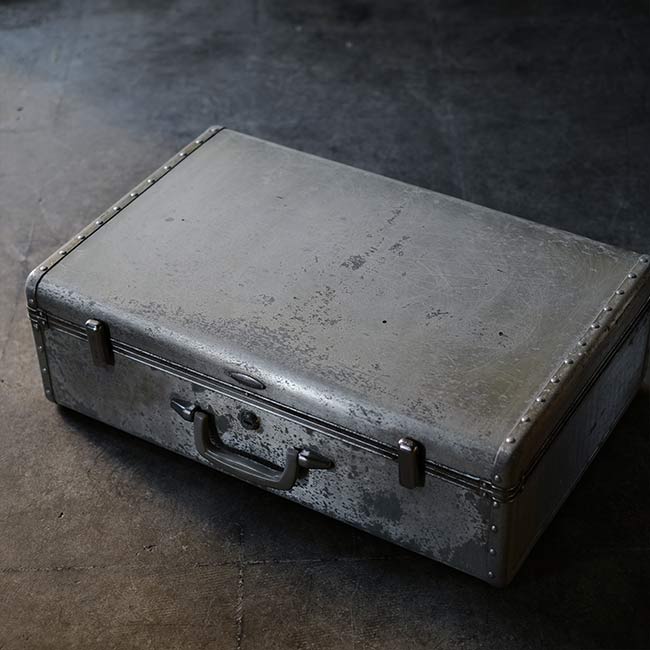 A well-worn aluminum trunk