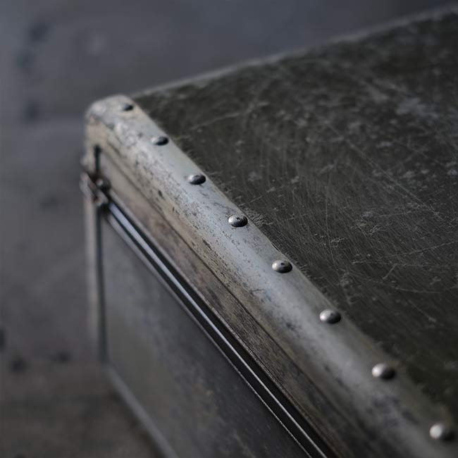 A well-worn aluminum trunk