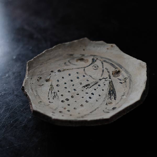 Remains of a fish-patterned bowl
