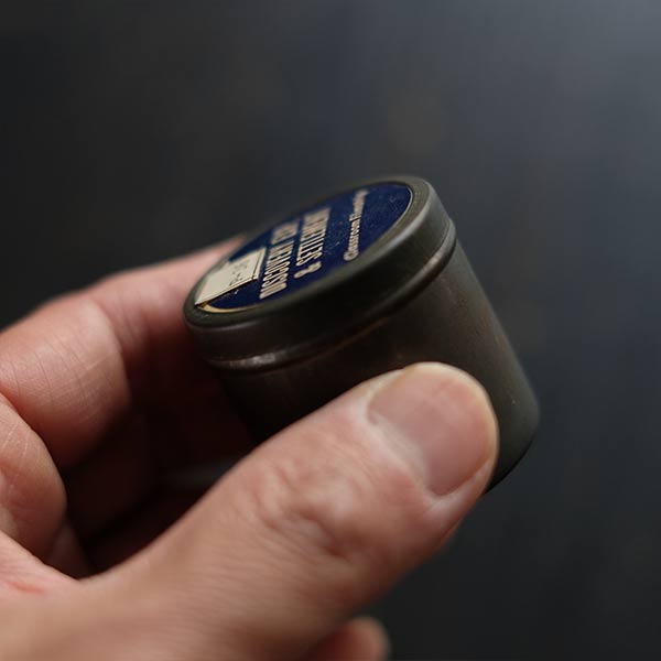 Tin case containing film