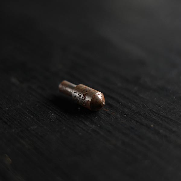 The tip of a tool in a wooden tube