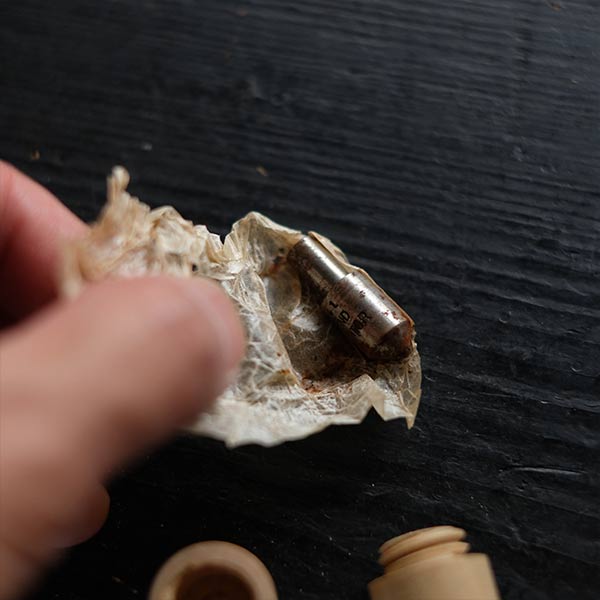 The tip of a tool in a wooden tube