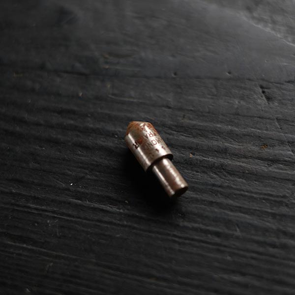 The tip of a tool in a wooden tube