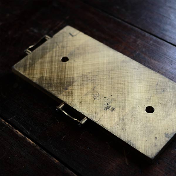 Brass plate with a small handle