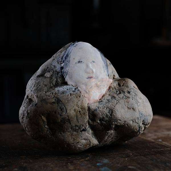 Noh mask painted on stone
