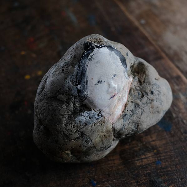 Noh mask painted on stone