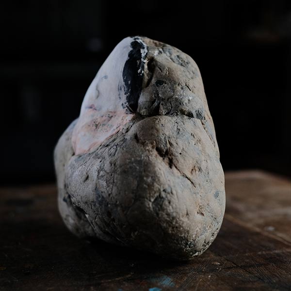 Noh mask painted on stone