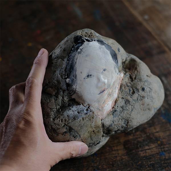 Noh mask painted on stone