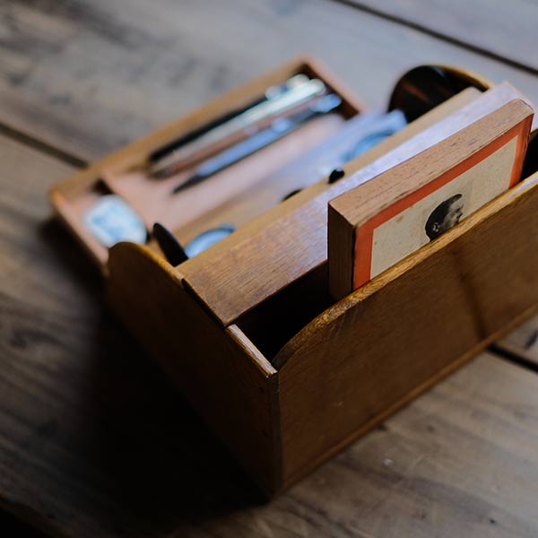 Accordion-style storage box with lid and drawer
