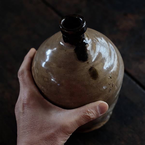 A slightly bent sake bottle