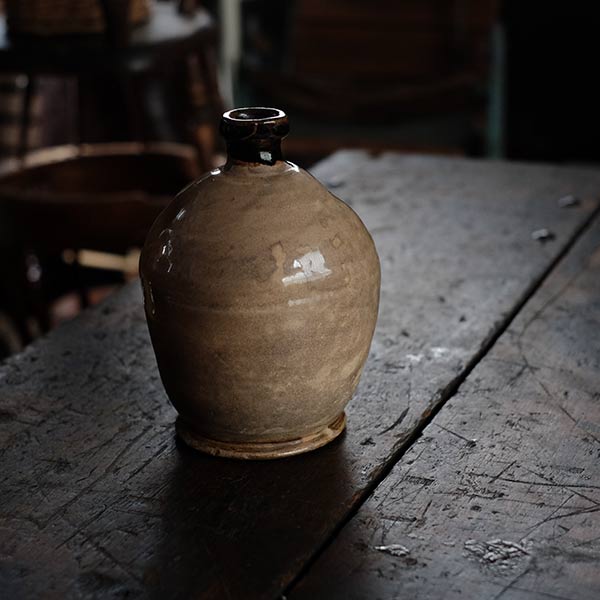 A slightly bent sake bottle