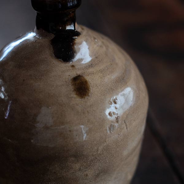 A slightly bent sake bottle