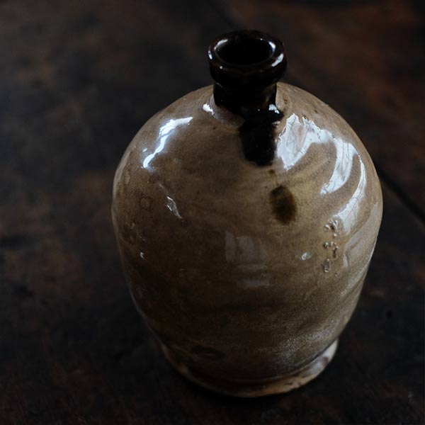 A slightly bent sake bottle