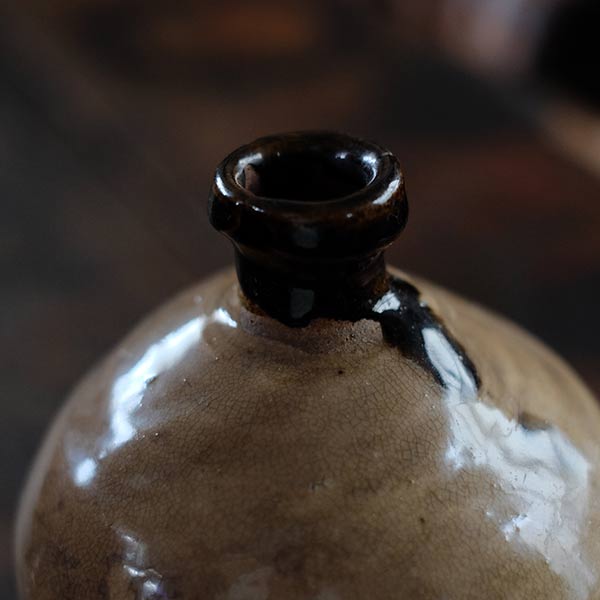 A slightly bent sake bottle