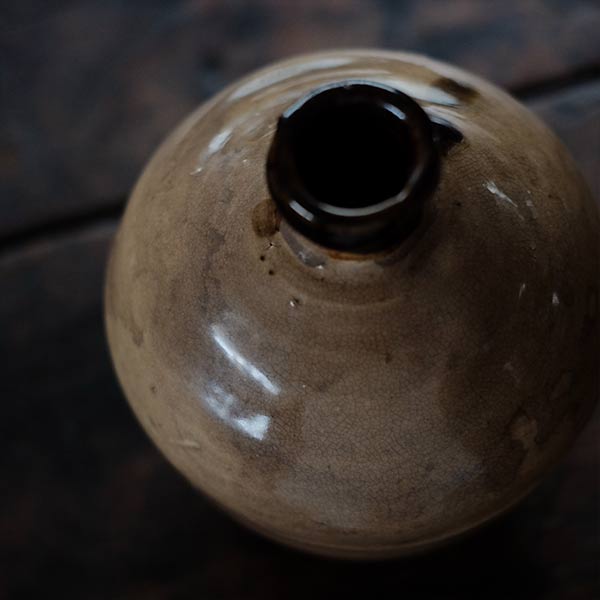 A slightly bent sake bottle