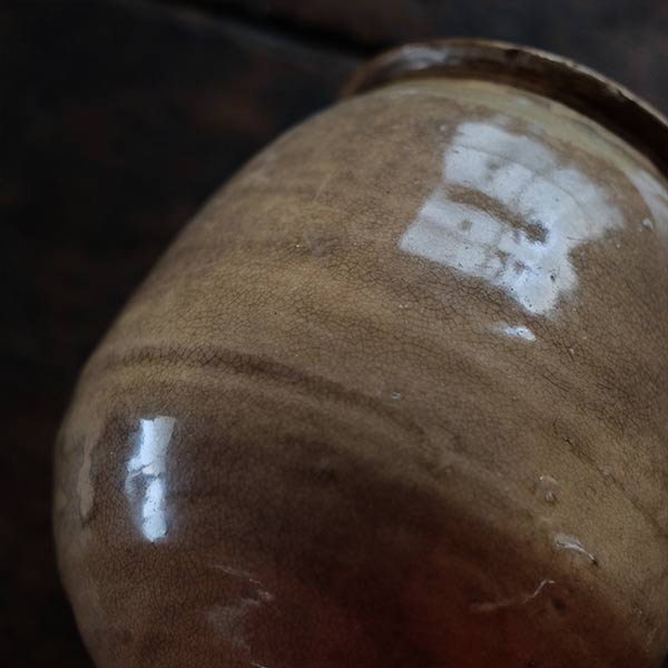 A slightly bent sake bottle