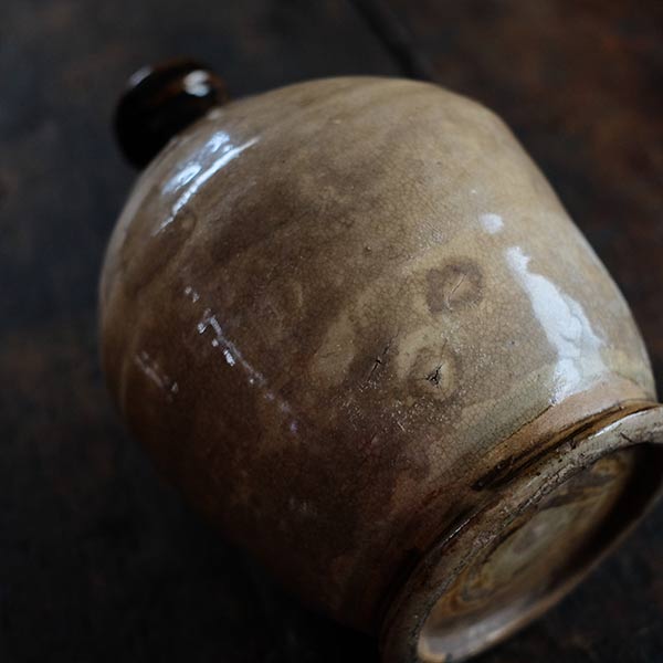 A slightly bent sake bottle