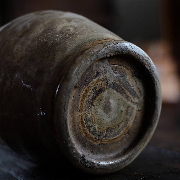 A slightly bent sake bottle
