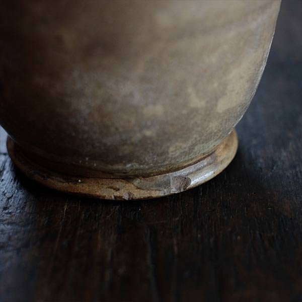 A slightly bent sake bottle