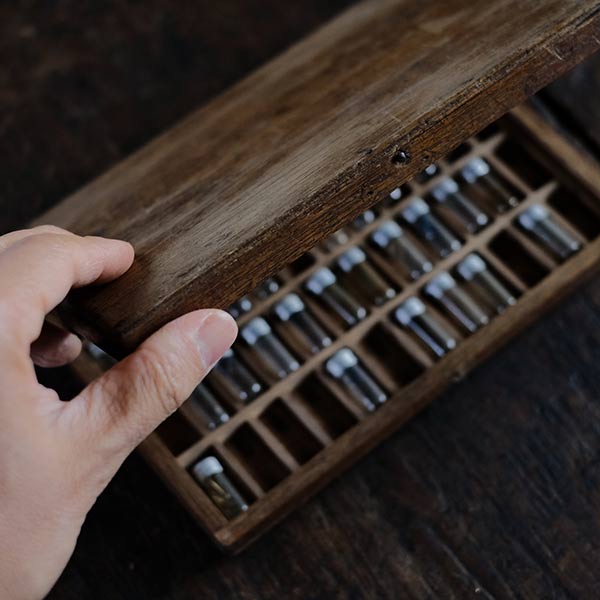 A set of watch parts in a small bottle