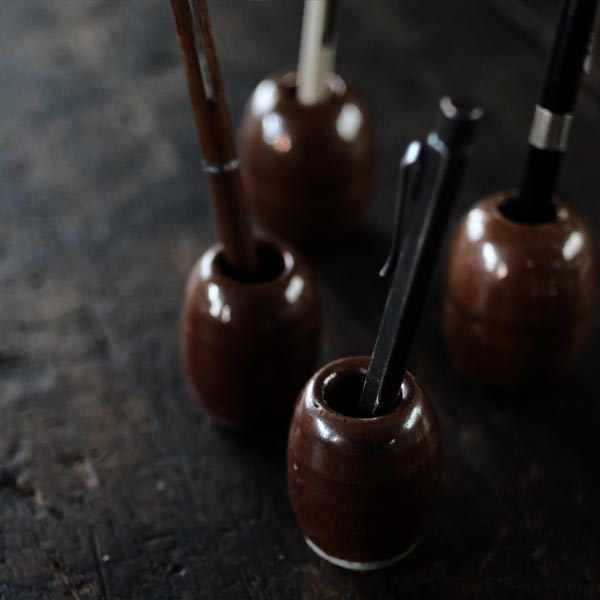 Ceramic sinkers attached to fishing nets