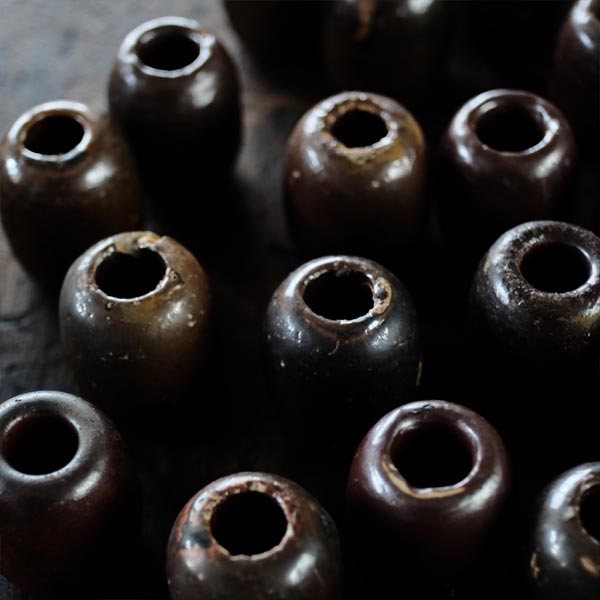 Ceramic sinkers attached to fishing nets