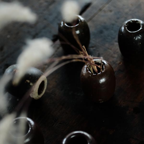 Ceramic sinkers attached to fishing nets