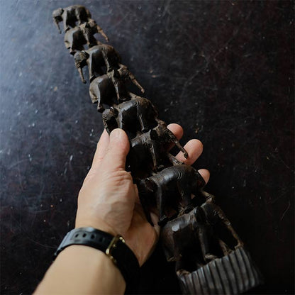 Eight carved wooden elephants