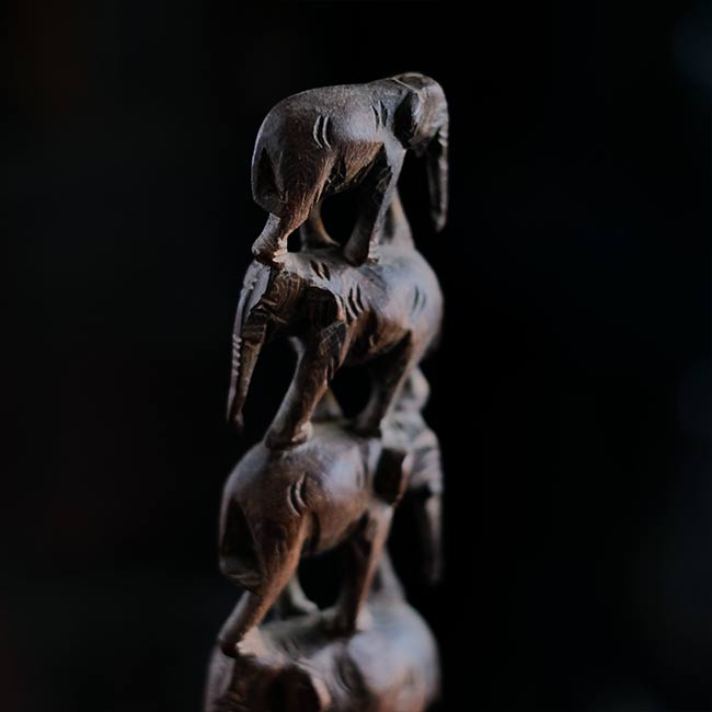 Eight carved wooden elephants