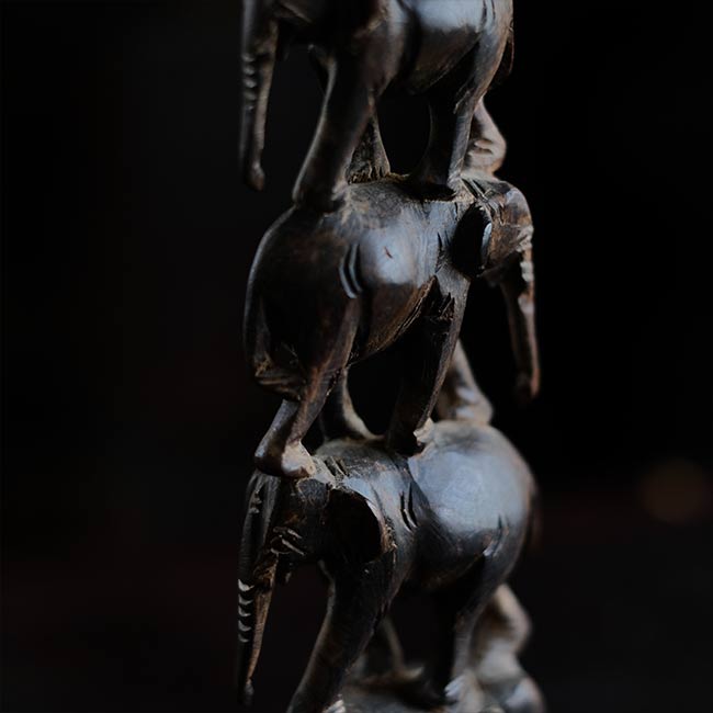 Eight carved wooden elephants