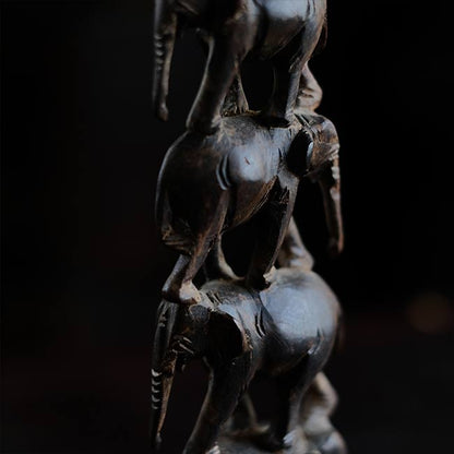 Eight carved wooden elephants