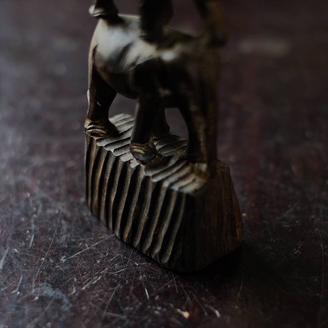 Eight carved wooden elephants