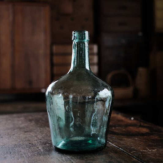 A fairly small aqua blue demijohn bottle