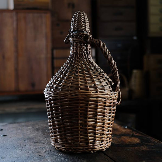 Rattan-wrapped glass bottle